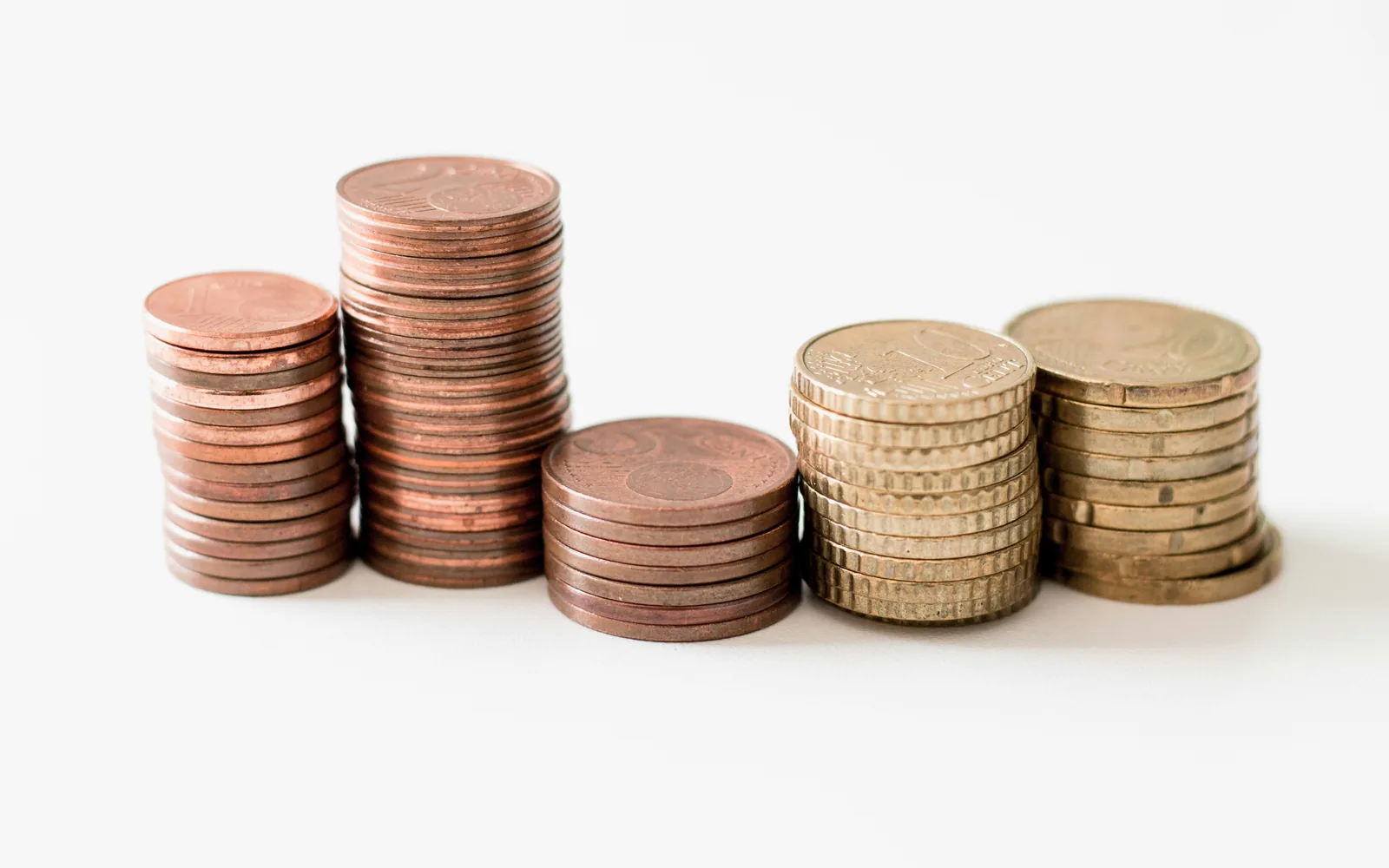 Stacks of coins on a white surface