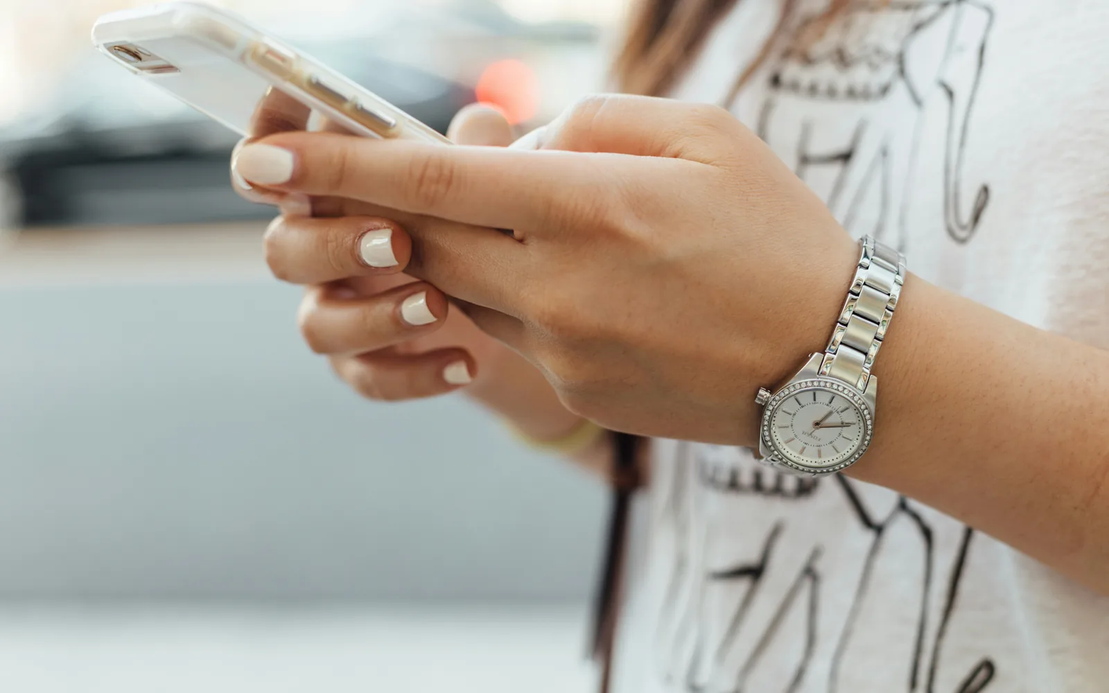 Hands typing a message on a phone