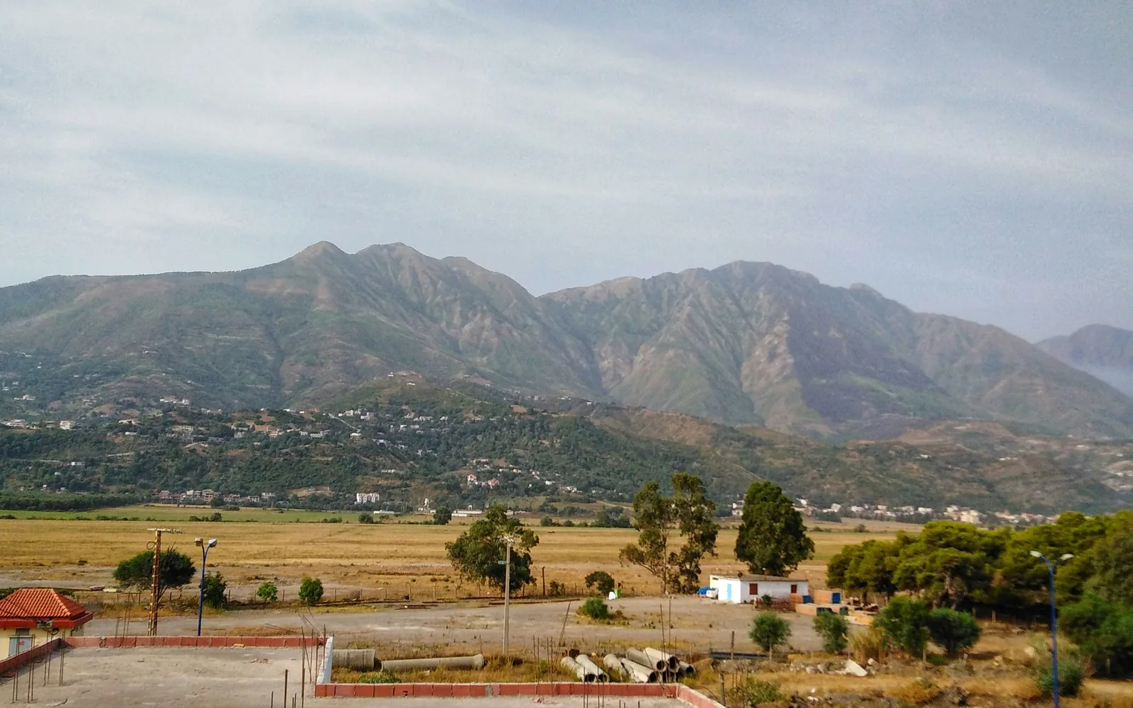 green grass field near mountain during daytime