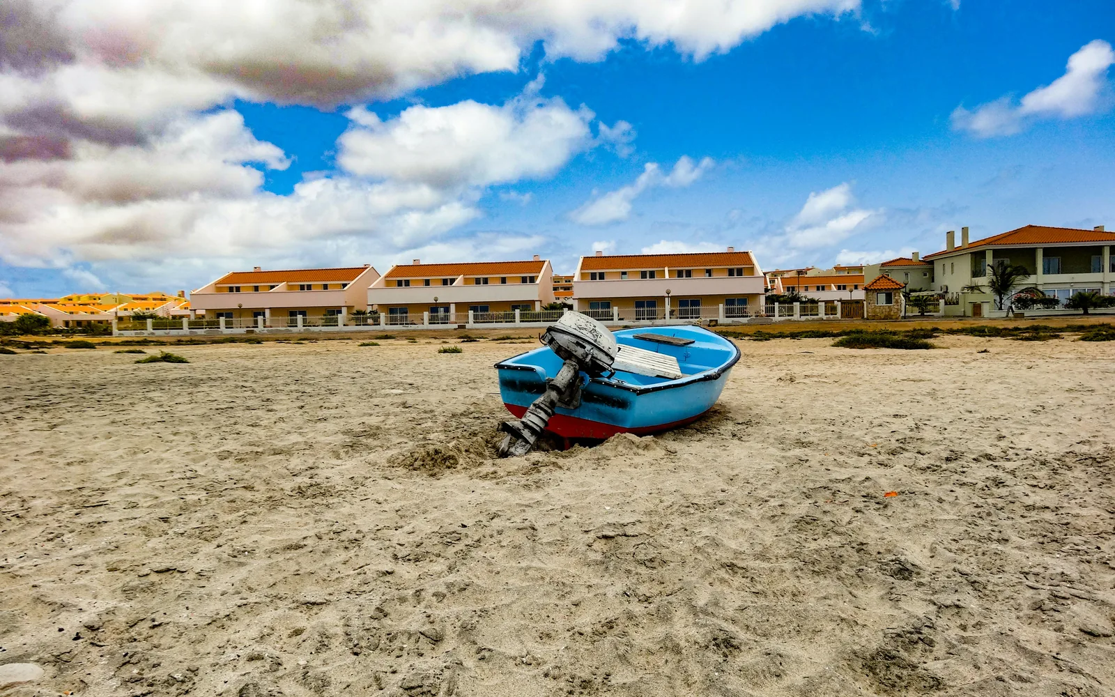 Sal, Cape Verde - May 03 2018: Small boat on the beach with houses in the background.
