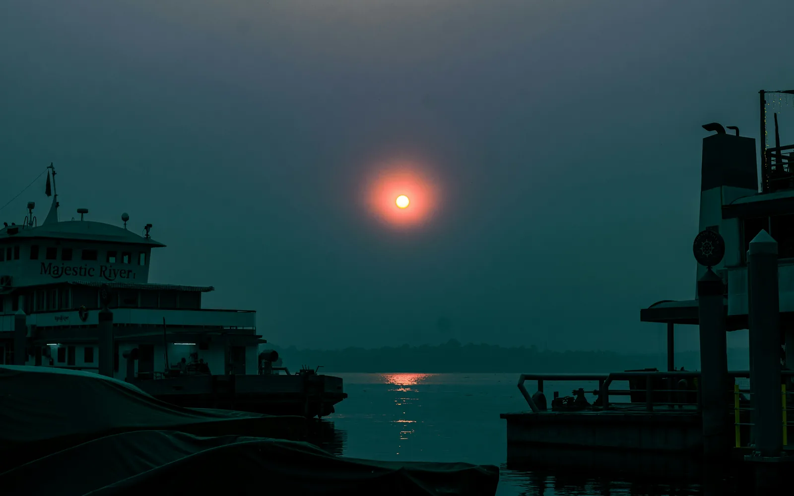 The sun is setting over a body of water