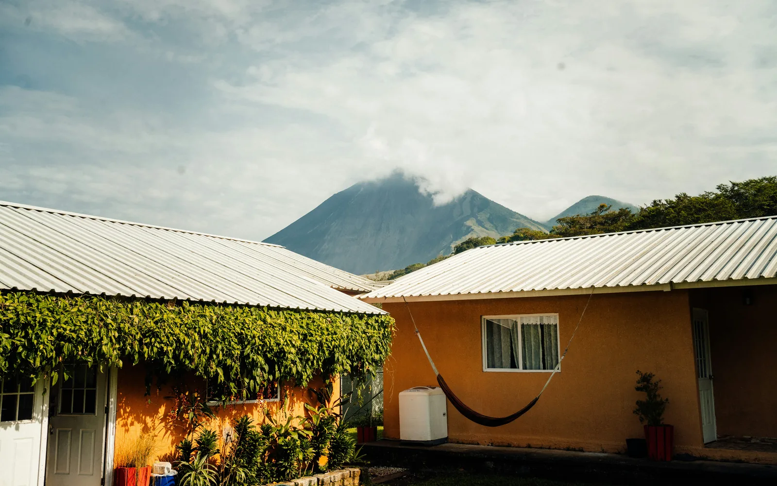 a house with a hammock hanging from it's roof