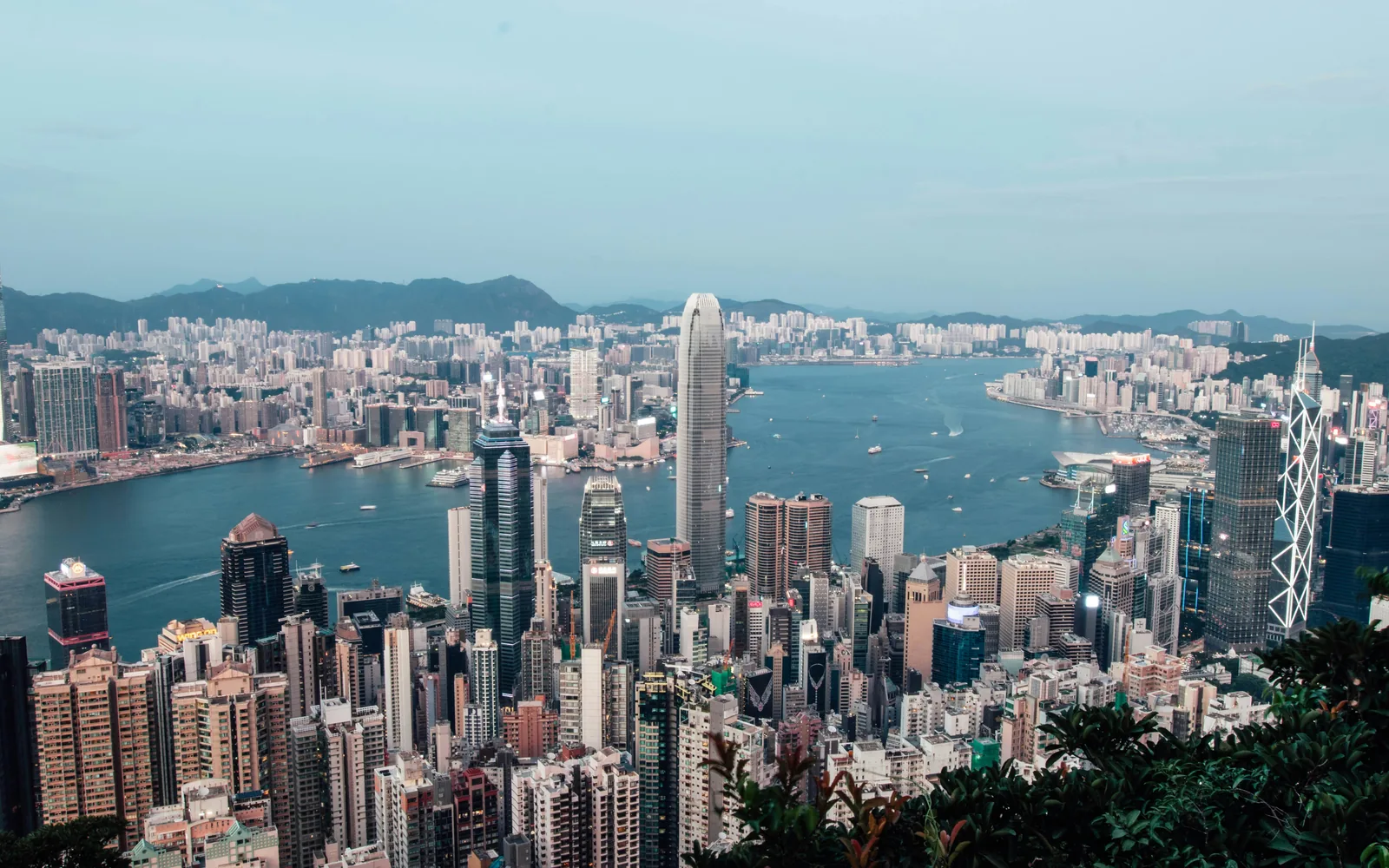 Panoramic view of a bustling city skyline across a bay.