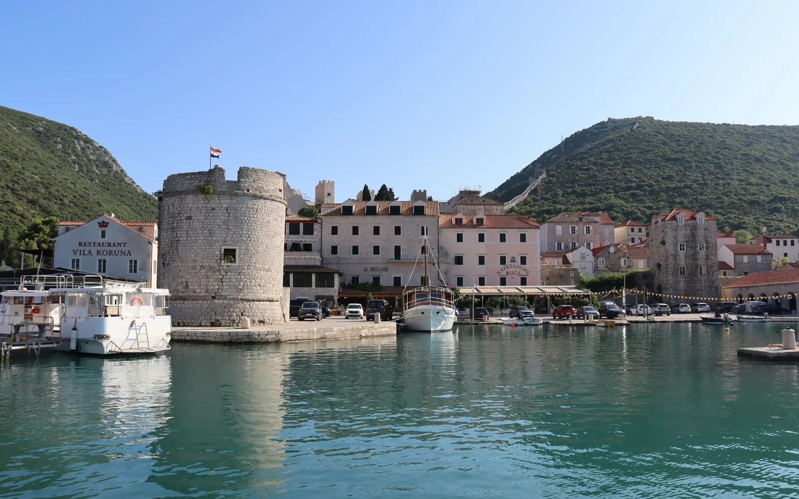 Coastal town with a round tower and boats