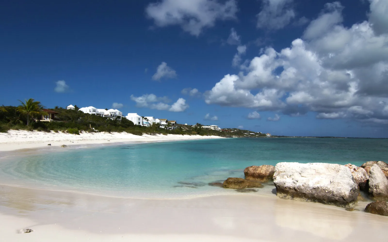 A beautiful tropical beach with white sand and turquoise water.