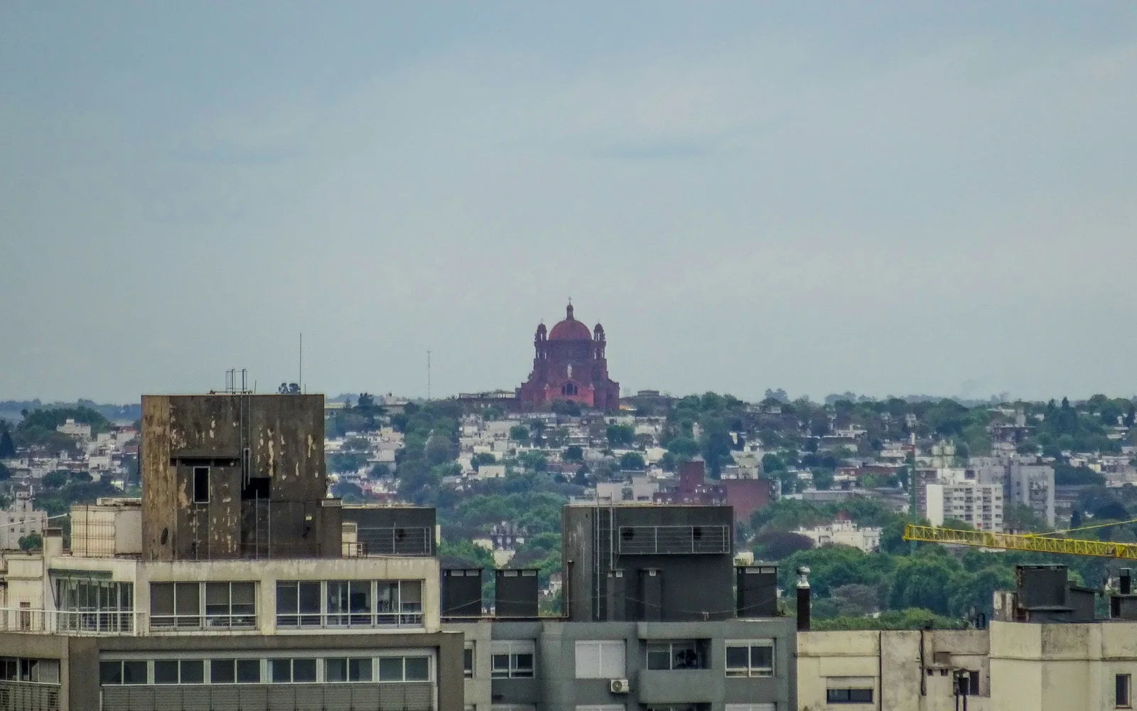 City skyline with a prominent red building in distance.